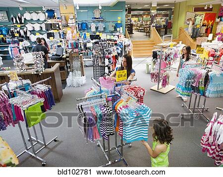 Mixed race mother and daughter shopping for children's clothing View Large Photo Image Stock Image - Mixed race mother and daughter shopping for children's clothing. Fotosearch