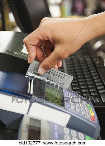 Mixed race woman swiping credit card in store View Large Photo Image Stock Photo - Mixed race woman swiping credit card in store. Fotosearch