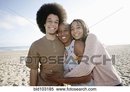 Mother and children hugging on beach View Large Photo Image Stock Photography - Mother and children hugging on beach. Fotosearch