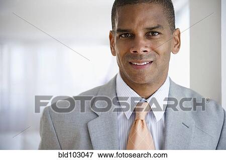 Stock Photo - Serious mixed race businessman. Fotosearch