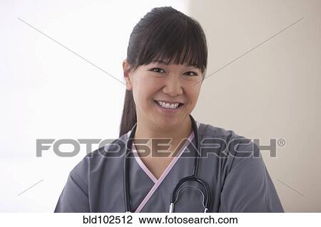 Stock Image - Smiling Asian surgeon. Fotosearch