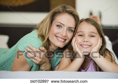 Smiling Hispanic mother and daughter View Large Photo Image Stock Photo - Smiling Hispanic mother and daughter. Fotosearch