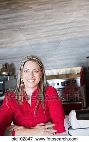 Stock Photo - Smiling Hispanic woman in cafe. Fotosearch
