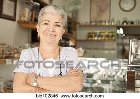 Stock Photograph - Smiling Hispanic woman in cafe. Fotosearch