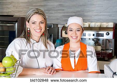 Smiling Hispanic workers in cafe View Large Photo Image Stock Photo - Smiling Hispanic workers in cafe. Fotosearch