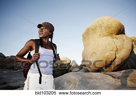 Stock Photography - Woman hiking in remote area. Fotosearch