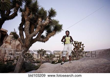 Woman hiking on large rock View Large Photo Image Stock Photo - Woman hiking on large rock. Fotosearch