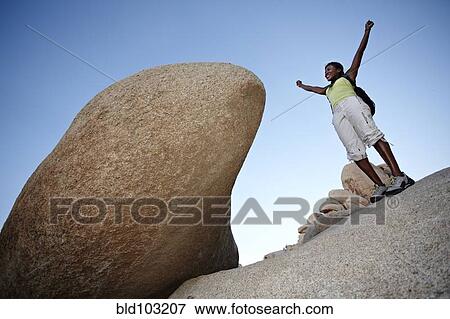 Woman hiking on large rocks View Large Photo Image Stock Photo - Woman hiking on large rocks. Fotosearch