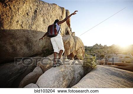 Woman hiking over large rocks View Large Photo Image Picture - Woman hiking over large rocks. Fotosearch