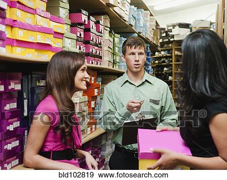 Workers talking in stockroom View Large Photo Image Stock Photo - Workers talking in stockroom. Fotosearch