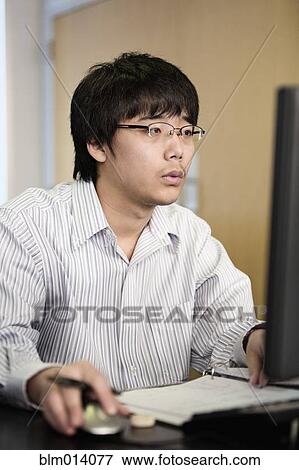 Stock Photo - Asian student studying with computer. Fotosearch