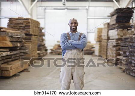 Black worker in lumber warehouse View Large Photo Image Stock Image - Black worker in lumber warehouse. Fotosearch