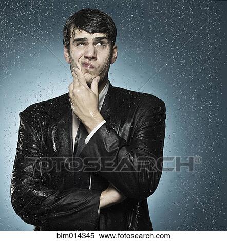 Stock Photography - Caucasian businessman caught in the rain. Fotosearch