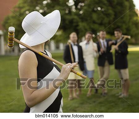 Stock Photography - Caucasian friends playing croquet together. Fotosearch