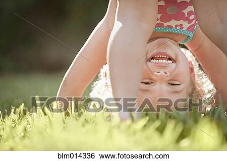 Caucasian girl playing in grass View Large Photo Image Stock Photograph - Caucasian girl playing in grass. Fotosearch