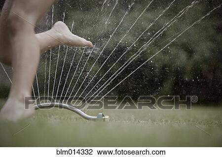 Caucasian girl running through sprinkler View Large Photo Image Stock Image - Caucasian girl running through sprinkler. Fotosearch