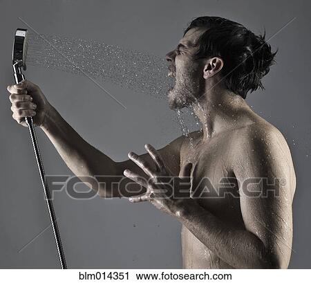 Caucasian man spraying himself in the face with shower View Large Photo Image Stock Image - Caucasian man spraying himself in the face with shower. Fotosearch
