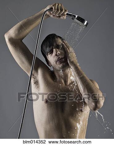 Stock Image - Caucasian man taking a shower. Fotosearch