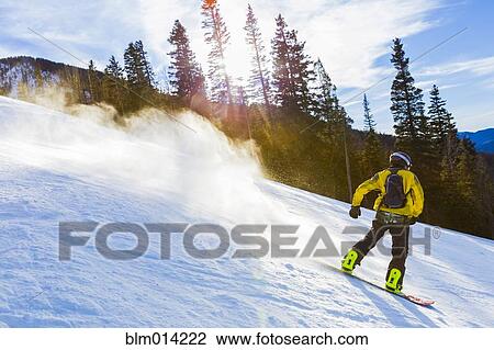 Stock Image - Caucasian teenager snowboarding. Fotosearch