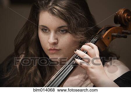 Stock Photo - Caucasian woman playing cello. Fotosearch