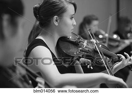 Caucasian woman playing violin in orchestra View Large Photo Image Stock Photograph - Caucasian woman playing violin in orchestra. Fotosearch