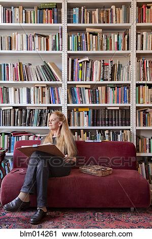 Caucasian woman sitting on sofa sketching View Large Photo Image Stock Image - Caucasian woman sitting on sofa sketching. Fotosearch