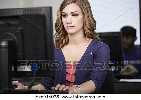Stock Photography - Caucasian woman studying in computer lab. Fotosearch