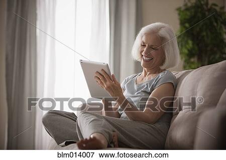 Stock Photo - Caucasian woman using digital tablet. Fotosearch