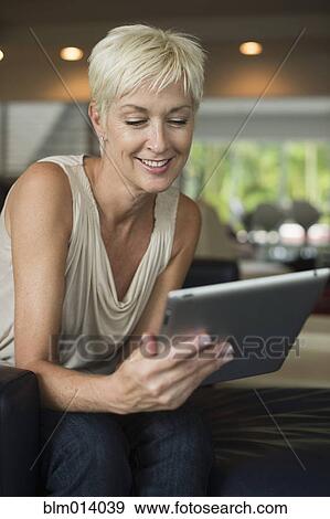 Stock Photo - Caucasian woman using digital tablet. Fotosearch