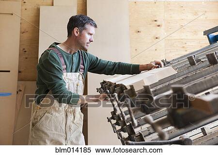 Caucasian worker cutting lumber in factory View Large Photo Image Stock Photography - Caucasian worker cutting lumber in factory. Fotosearch