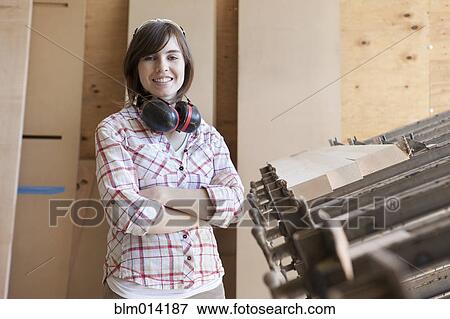 Caucasian worker with headphones in factory View Large Photo Image Stock Photo - Caucasian worker with headphones in factory. Fotosearch