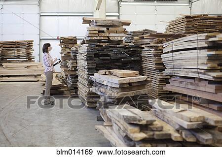 Caucasian worker with lumber in warehouse View Large Photo Image Stock Photo - Caucasian worker with lumber in warehouse. Fotosearch