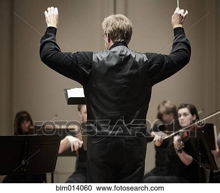 Conductor leading orchestra View Large Photo Image Stock Image - Conductor leading orchestra. Fotosearch