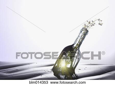 Stock Image - Floating bottle with flowers. Fotosearch