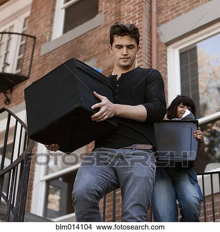 Friends carrying bins downstairs View Large Photo Image Picture - Friends carrying bins downstairs. Fotosearch