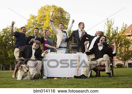 Stock Photograph - Friends enjoying elegant lawn party. Fotosearch