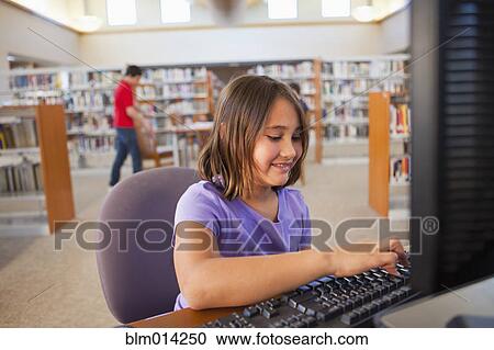 Girl using computer in library View Large Photo Image Stock Image - Girl using computer in library. Fotosearch