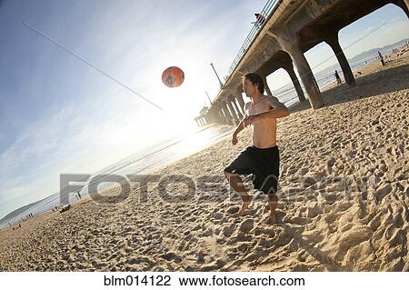 Hispanic man playing with soccer ball on beach View Large Photo Image Stock Image - Hispanic man playing with soccer ball on beach. Fotosearch