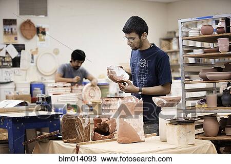 Stock Image - Indian man in pottery workshop. Fotosearch