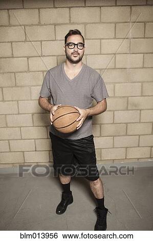 Man holding basketball View Large Photo Image Stock Photograph - Man holding basketball. Fotosearch
