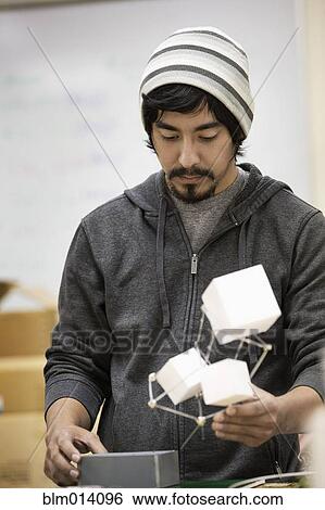 Man holding cubes and looking down View Large Photo Image Stock Photograph - Man holding cubes and looking down. Fotosearch