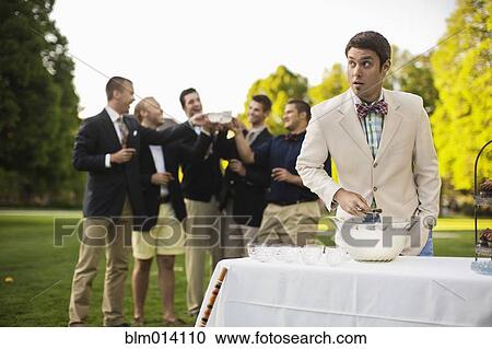 Man pouring alcohol into punch bowl View Large Photo Image Stock Image - Man pouring alcohol into punch bowl. Fotosearch