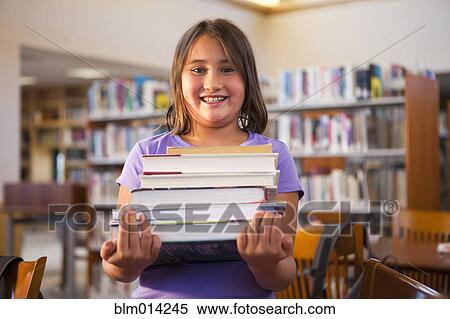 Stock Photography - Mixed race girl carrying library books. Fotosearch