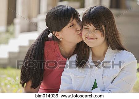 Stock Photograph - Mother kissing daughter. Fotosearch