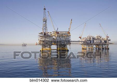 Oil rigs on the ocean View Large Photo Image Stock Image - Oil rigs on the ocean. Fotosearch