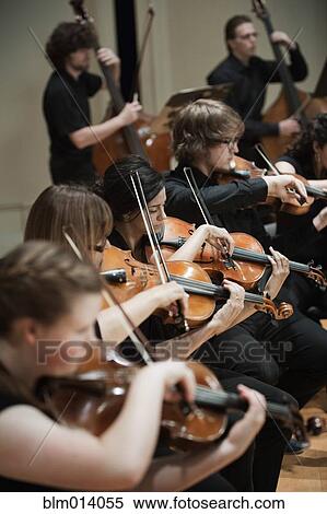 Orchestra playing musical instruments together View Large Photo Image Stock Photography - Orchestra playing musical instruments together. Fotosearch