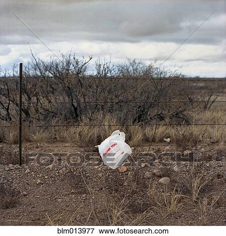 Plastic bag stuck on fence wire View Large Photo Image Stock Photo - Plastic bag stuck on fence wire. Fotosearch