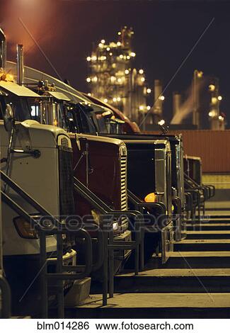 Semi-trucks in a row View Large Photo Image Stock Photograph - Semi-trucks in a row. Fotosearch