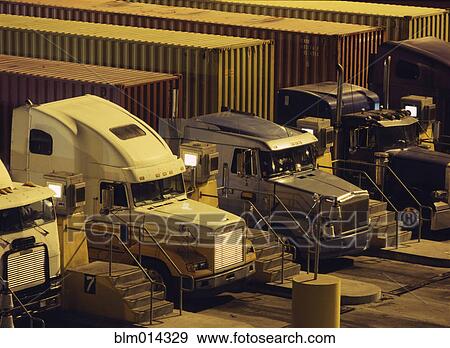 Stock Photo - Semi-trucks parked in a row. Fotosearch