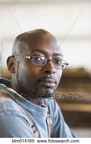 Stock Photography - Serious Black man in eyeglasses. Fotosearch